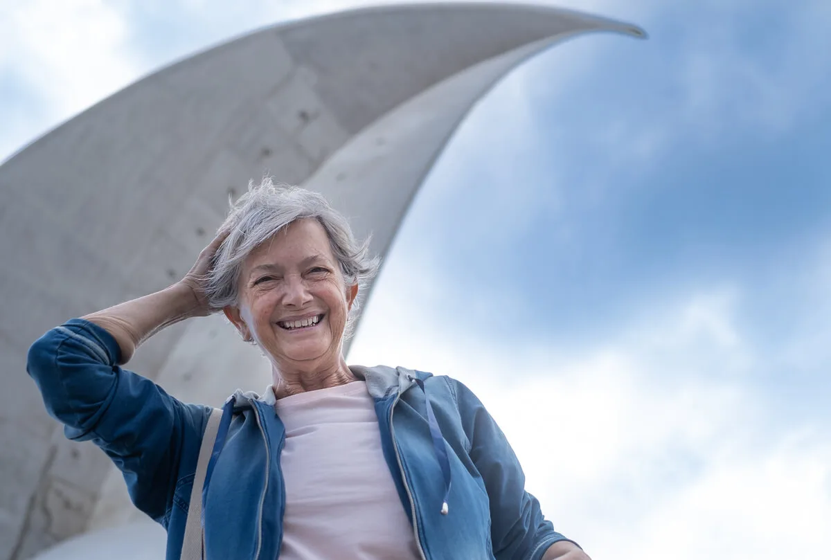 Senior woman smiling confidently after cosmetic dental care